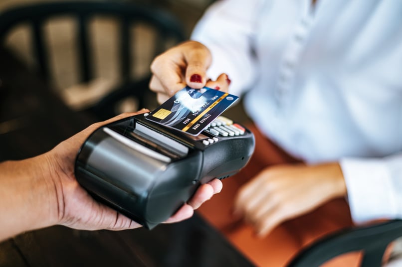 close-up-image-woman-paying-with-credit-card-cafe